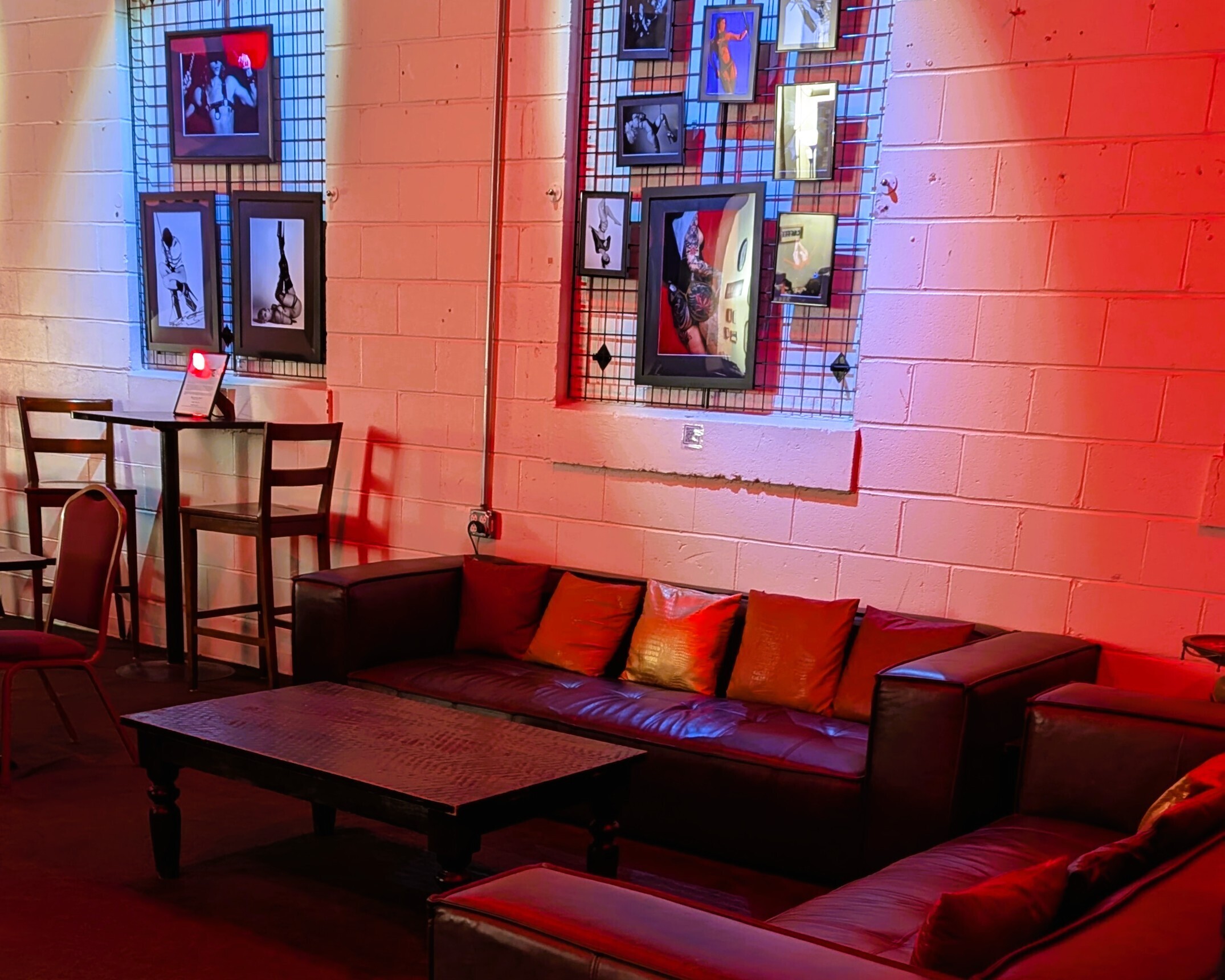 Gallery-style wall art and seating area at The Shop