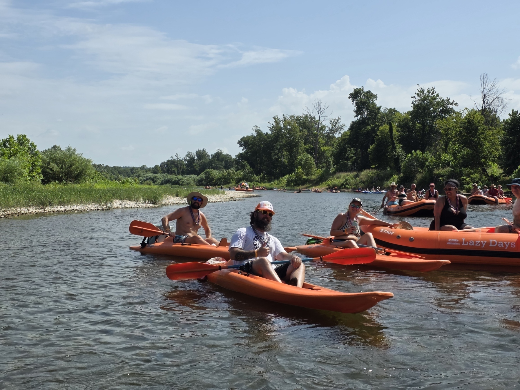 Line of kayaks and rafts floating down the river together